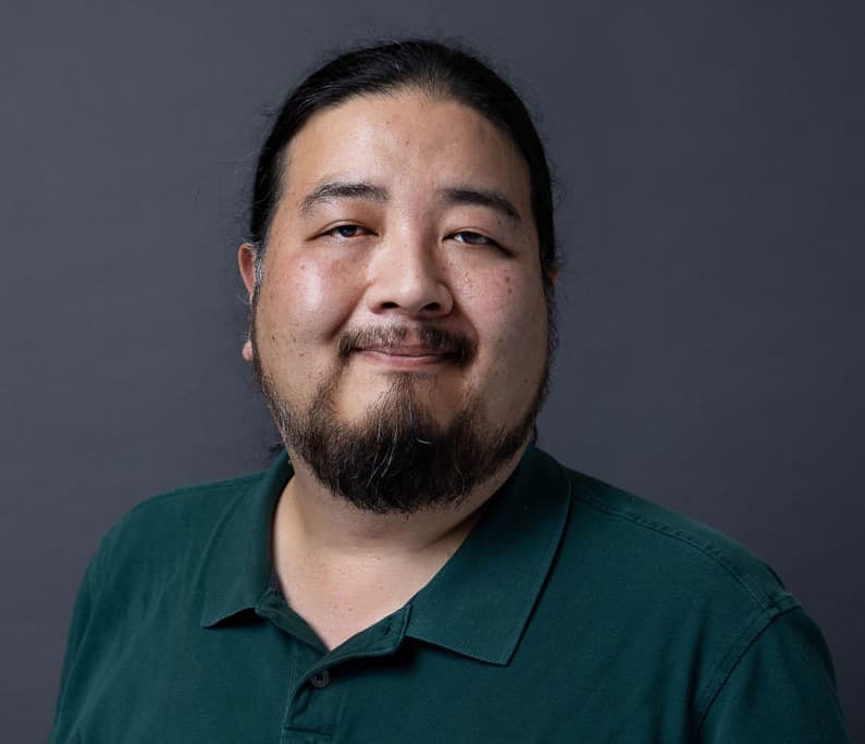 A smiling man in a green shirt